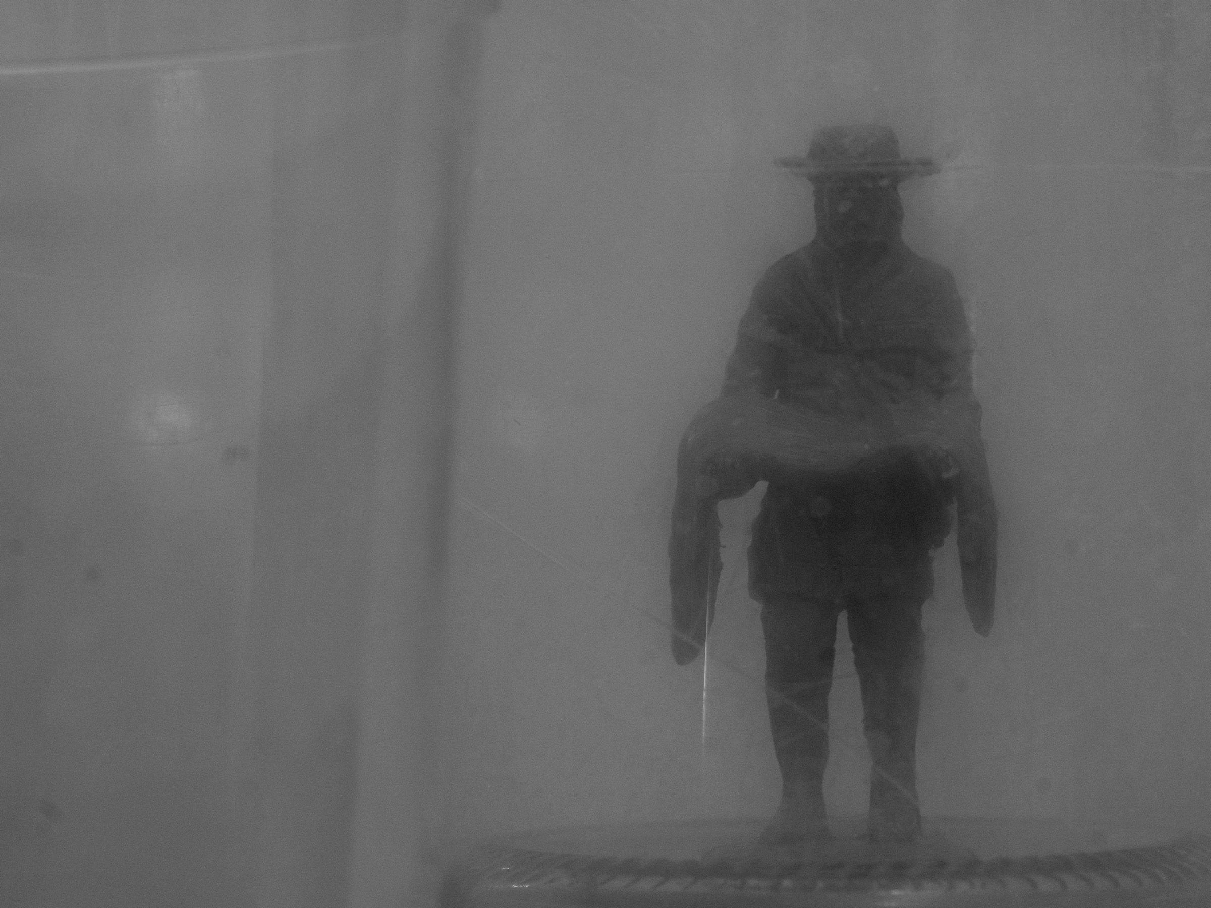 Hazy monochrome figure carrying another figure